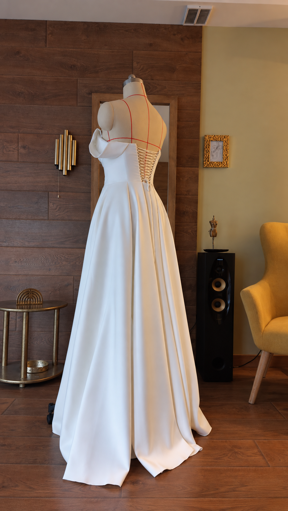 Rear angle of lace-up back and flowing wedding dress skirt